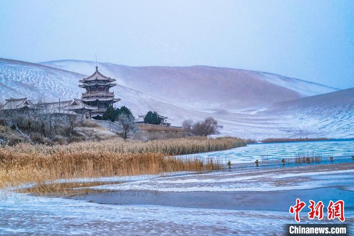 2021年11月28日，雪落鳴沙山月牙泉景區(qū)?！⊥醣筱y 攝