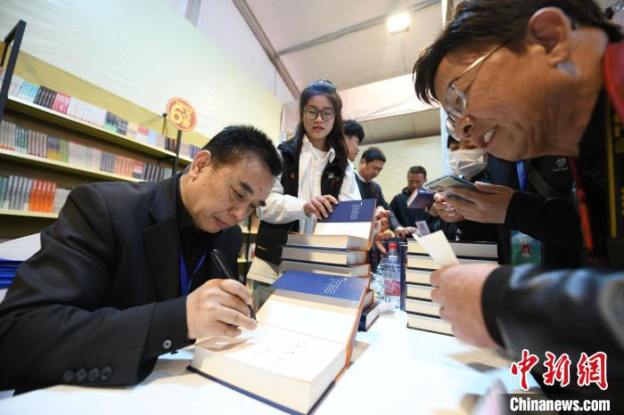 圖為作家王躍文現(xiàn)場簽名售書?！×赫赵?攝