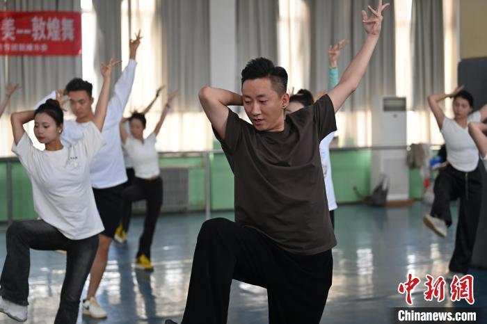 6月6日，在甘肅敦煌青年夜校課程中，青年學(xué)員學(xué)習(xí)敦煌舞課程。李亞龍 攝　　